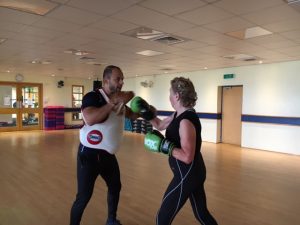 person-trainer-doing-boxing-training-with-customer